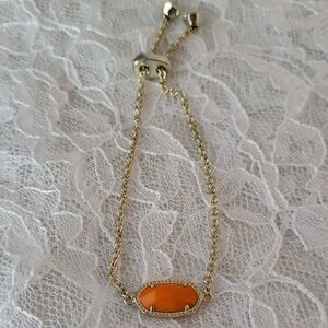 Kendra Scott Elaina Gold Adjustable Bracelet with Orange Pendant.